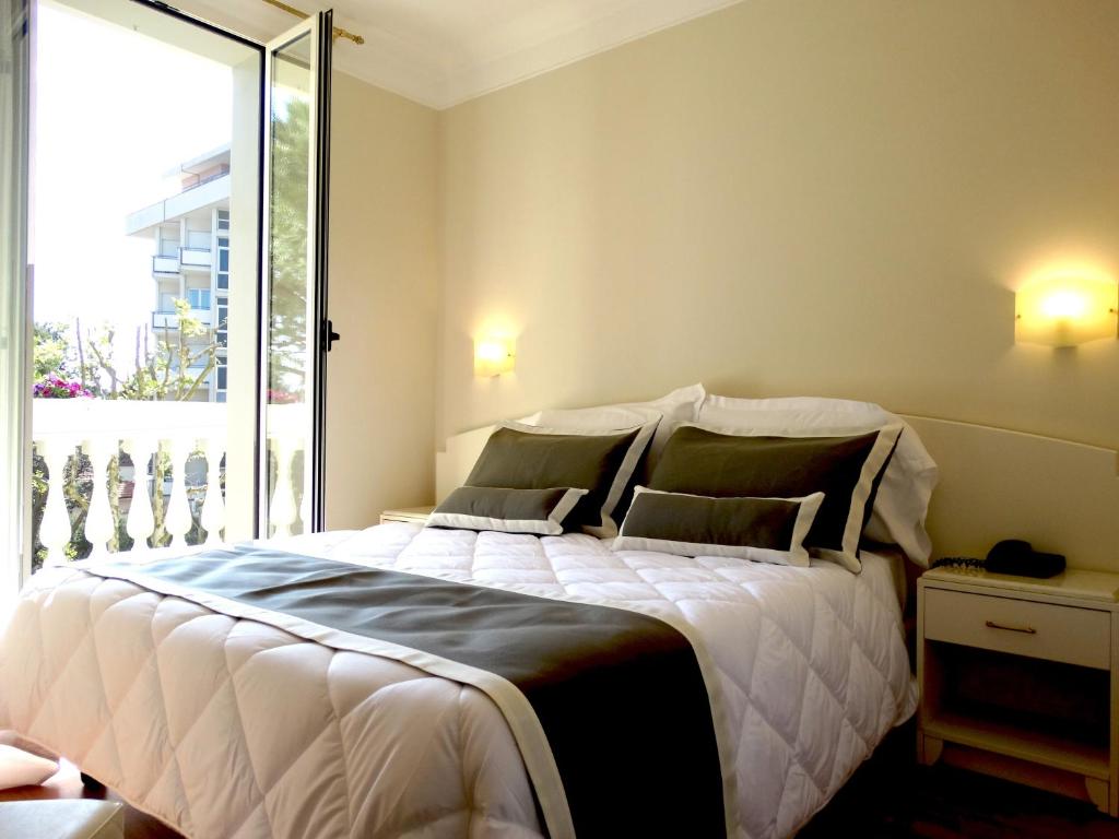 Postel nebo postele na pokoji v ubytování Novecento Suite Hotel