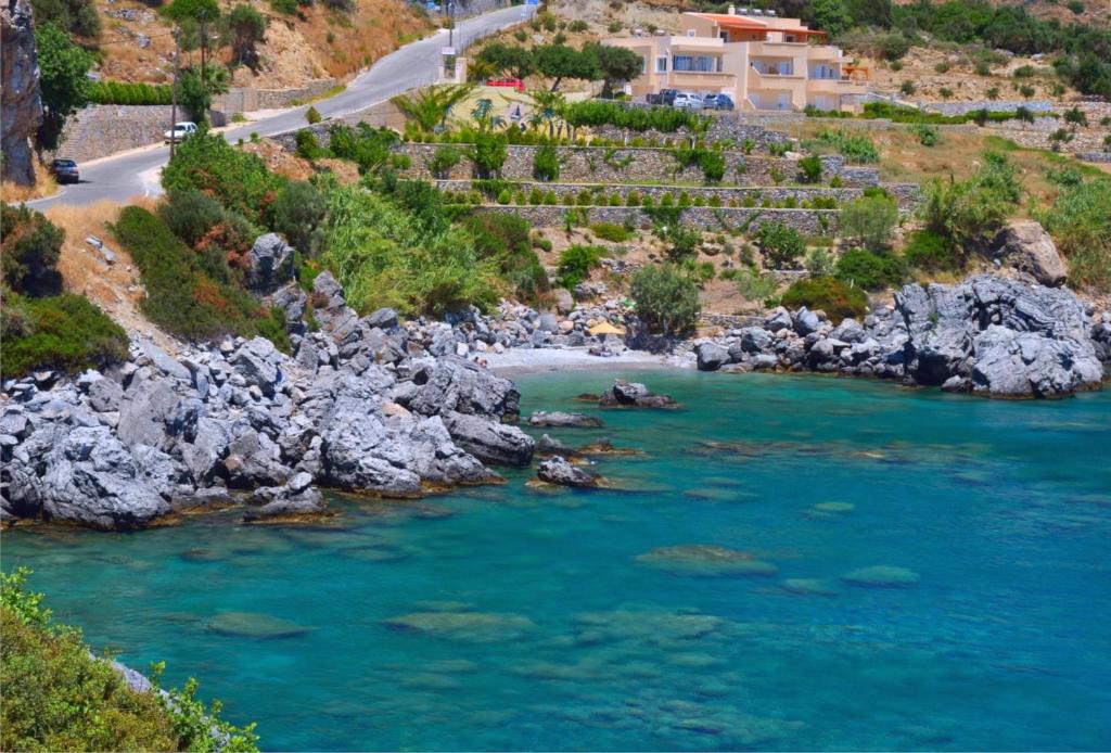 an aerial view of a river with blue water at Creta Spirit in Plakias