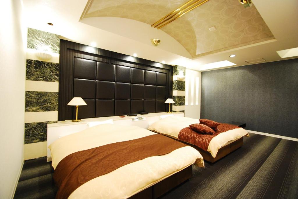 Postel nebo postele na pokoji v ubytování Hotel Free Style Okayama