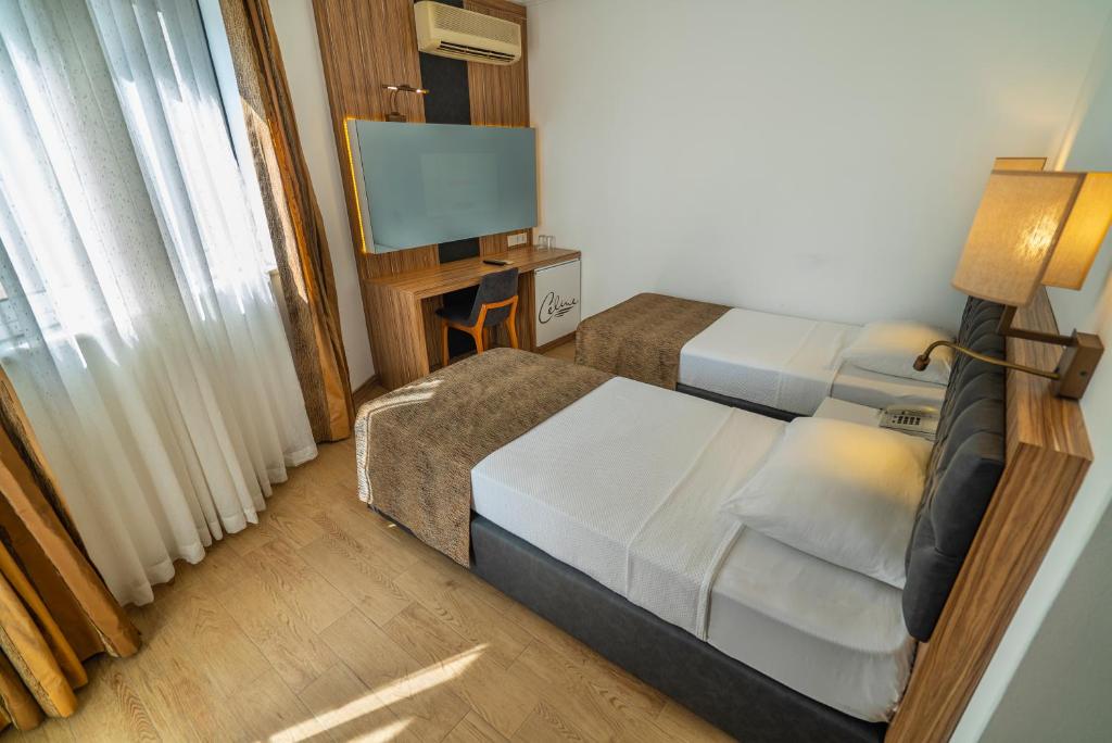 A bed or beds in a room at Kleopatra Celine Hotel