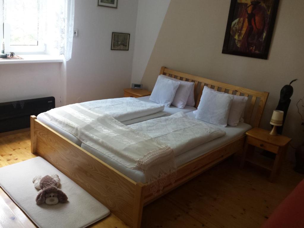 a bedroom with a bed with a teddy bear on it at Apartment Anna in Český Dub