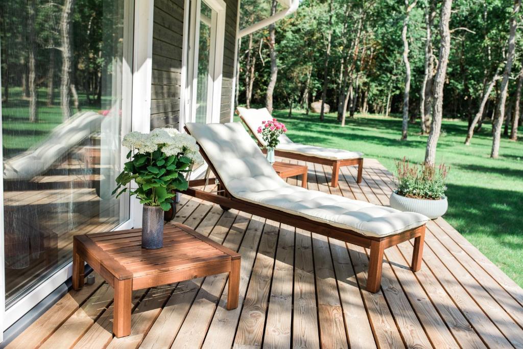 a porch with two chairs and tables on a house at The Peaceful Vacation in Muratsi
