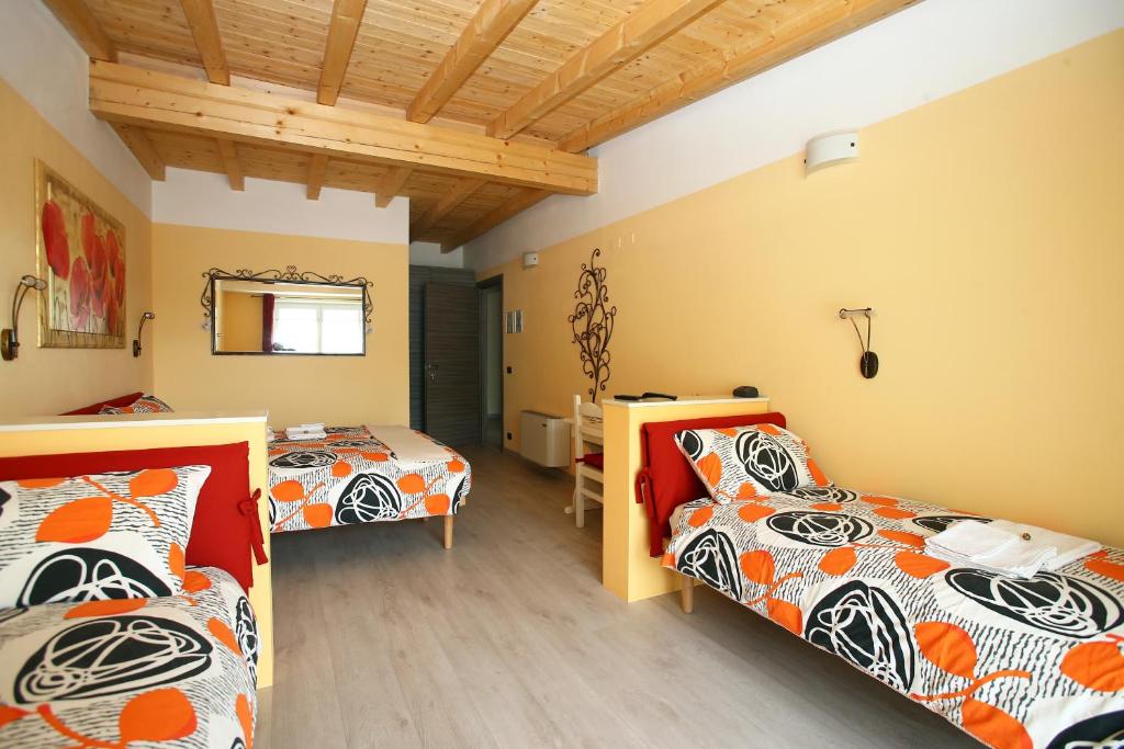 Postel nebo postele na pokoji v ubytování B&B La Vecchia Tipografia - Lago D'Idro