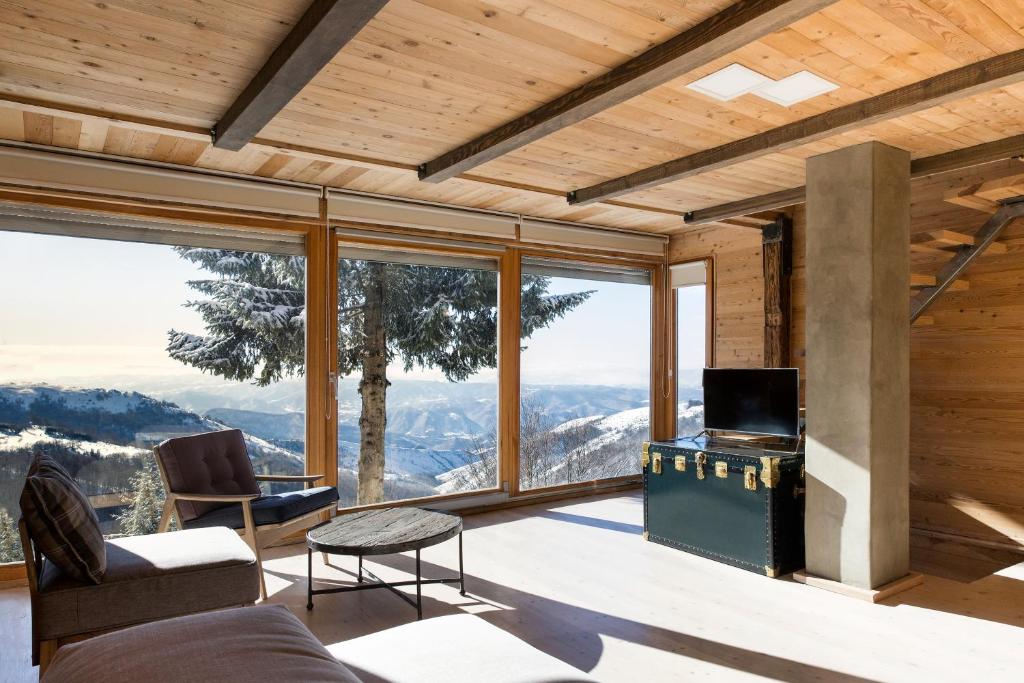 a living room with a view of the mountains at Kostovac Boutique Homes - House 1 in Kopaonik