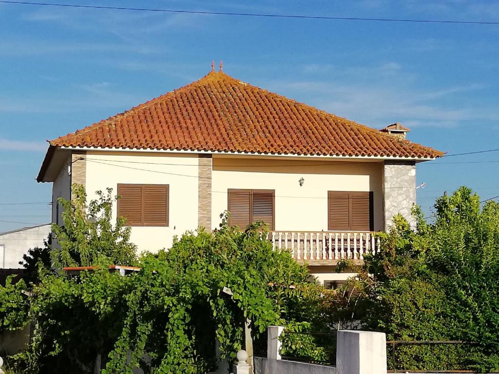 una gran casa blanca con techo rojo en Casa Conceição en Atalaia