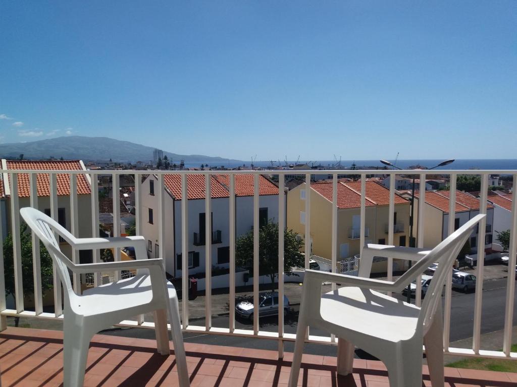 a pair of chairs sitting on a balcony at Varanda do Atlântico in Ponta Delgada