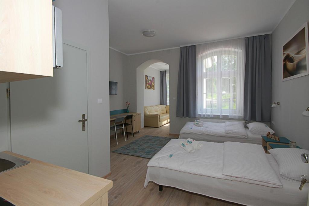 Postel nebo postele na pokoji v ubytování Willa Park Apartamenty