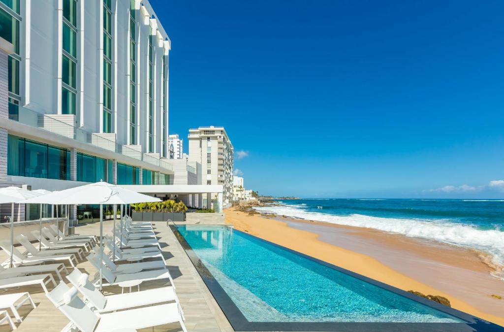 a view of the beach and a swimming pool and the ocean at Condado Ocean Club in San Juan