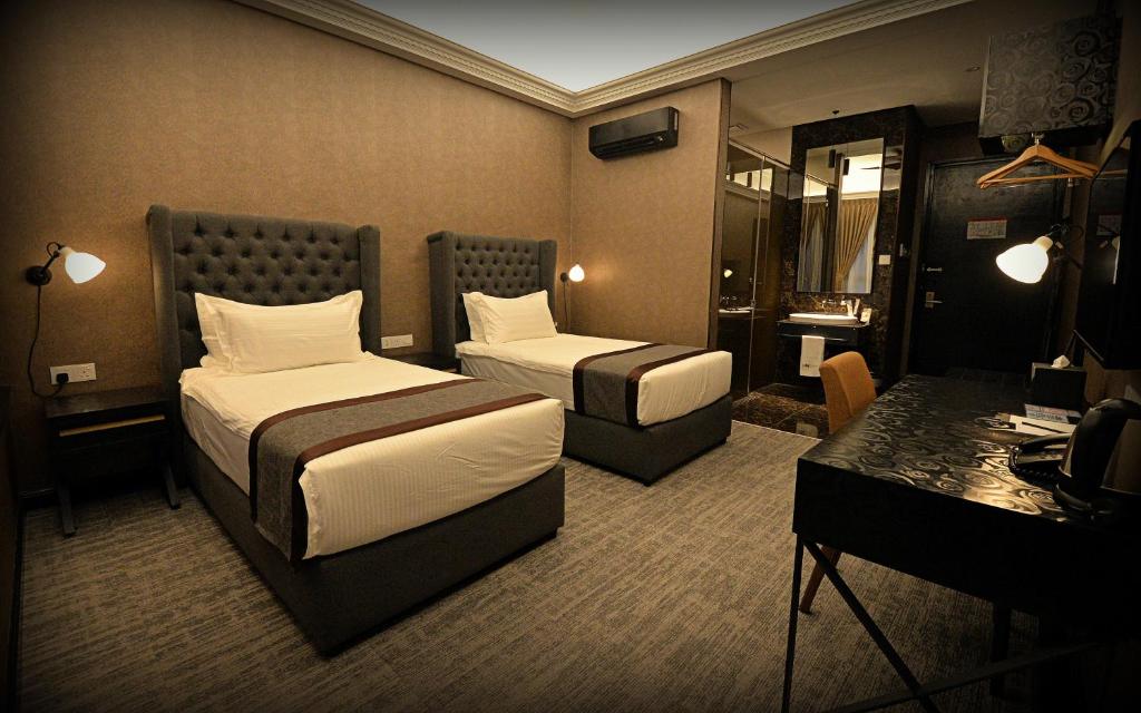 Postel nebo postele na pokoji v ubytování 1969 Business Suites Bandar Botani, Ipoh