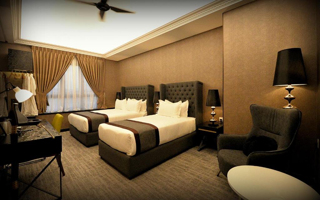 Postel nebo postele na pokoji v ubytování 1969 Business Suites Bandar Botani, Ipoh