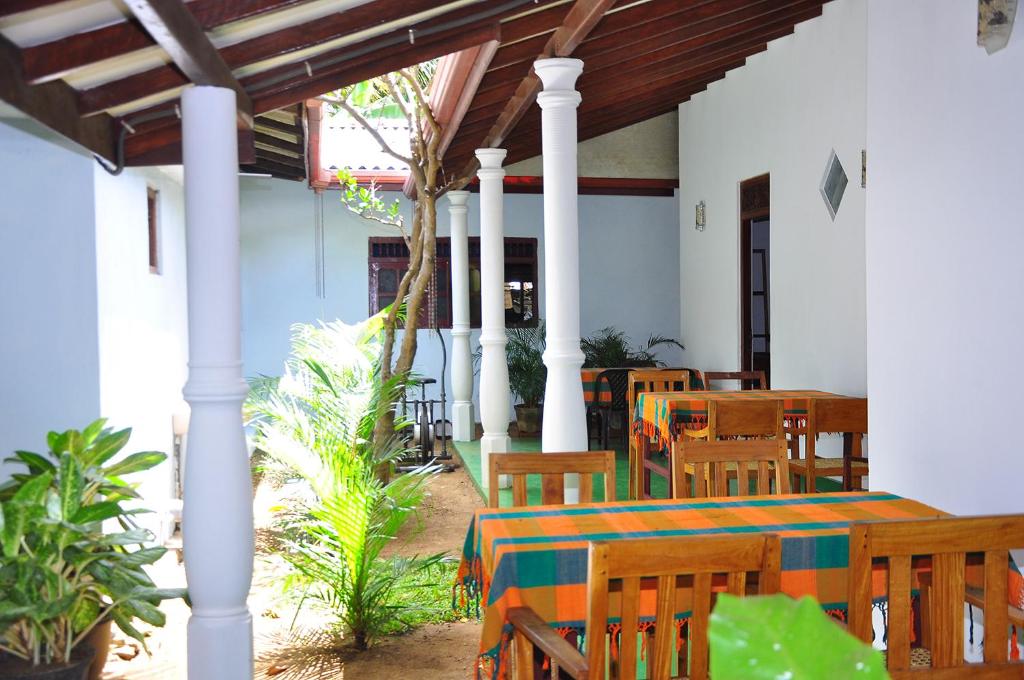 a dining room with a table and chairs in a building at Mother House in Anuradhapura