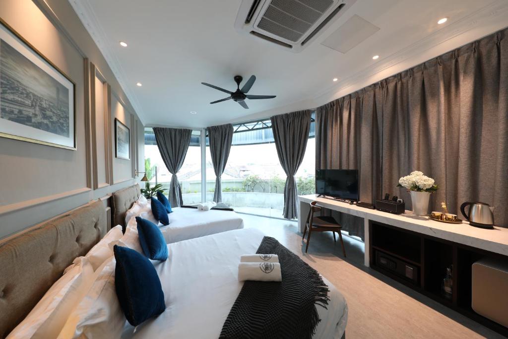 a living room with a large bed and a television at Reunion Residence in George Town