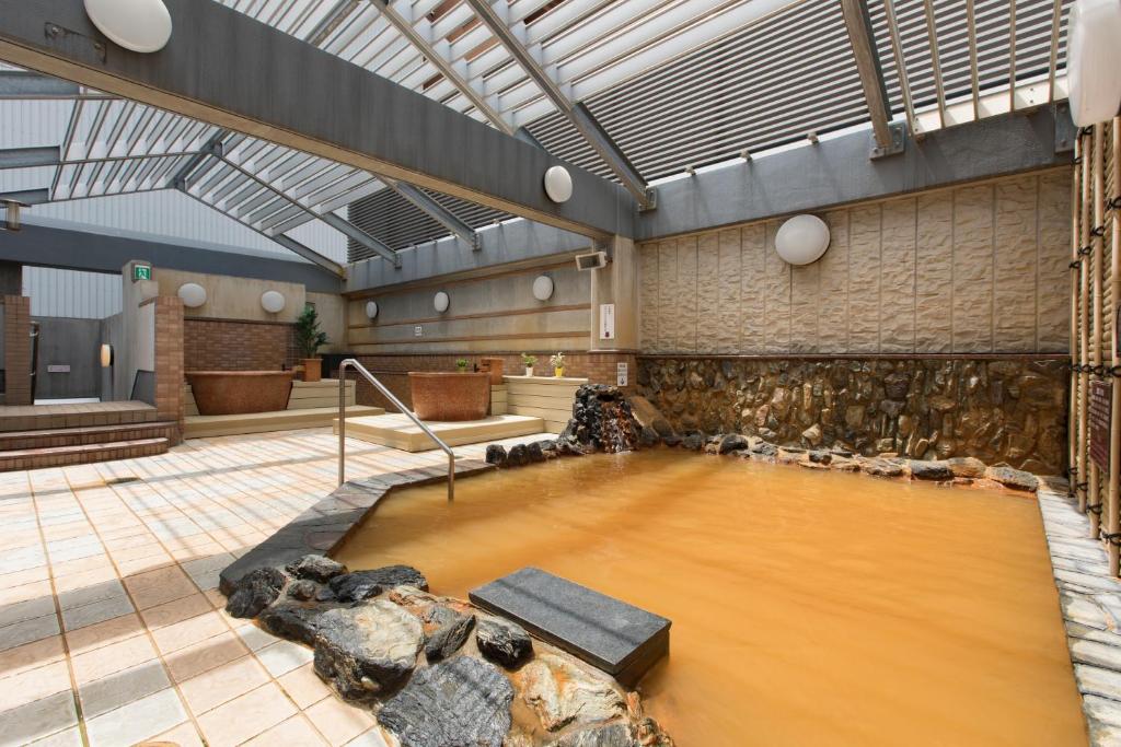 a large room with a large pool of water at Premier Hotel-CABIN-Sapporo in Sapporo