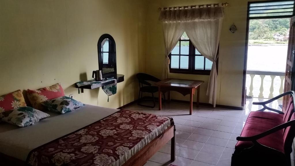 Postel nebo postele na pokoji v ubytování Sibayak Guesthouse