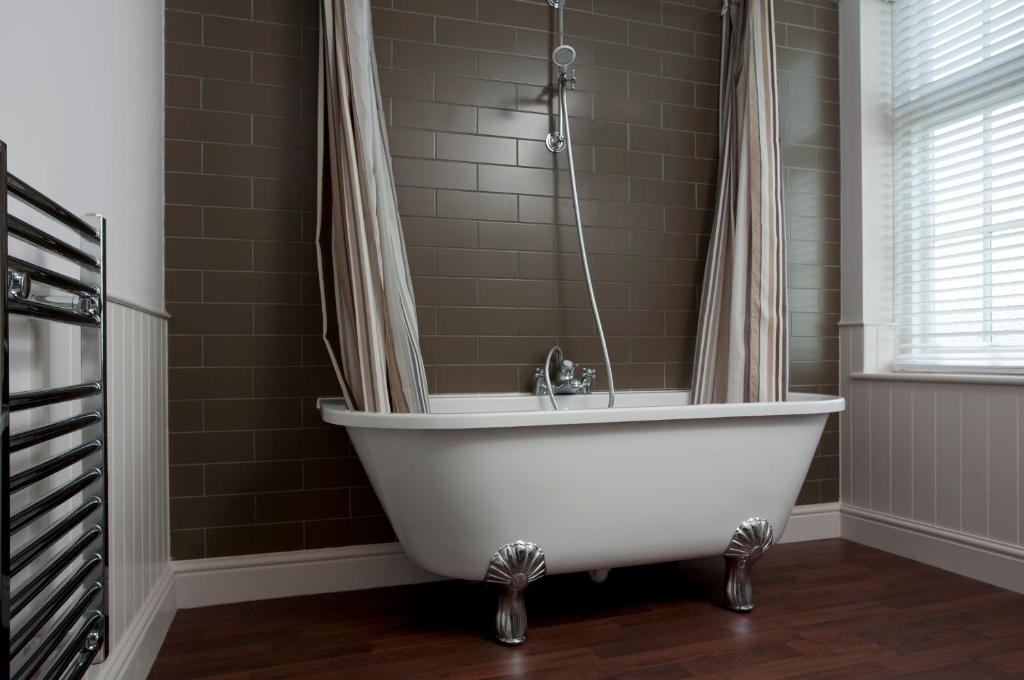 a white bath tub in a bathroom with a window at The Marine in Whitstable