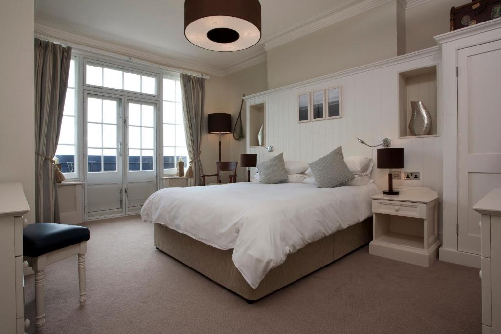 a bedroom with a large bed and a large window at The Marine in Whitstable