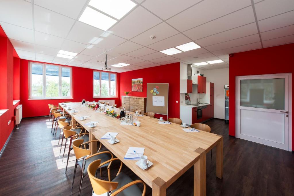 a large conference room with a long table and chairs at Café & mehr in Halle an der Saale