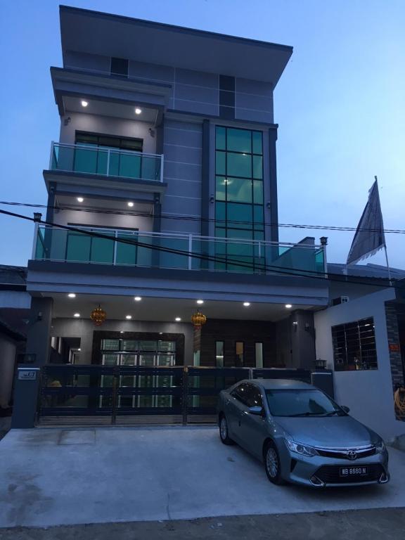 a car parked in front of a house at CK Homestay K.Sepetang in Taiping