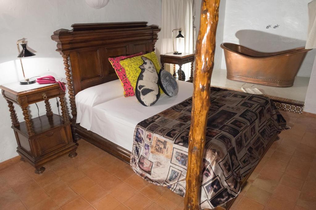a bedroom with a bed with a wooden bed frame at Pikes Ibiza in San Antonio