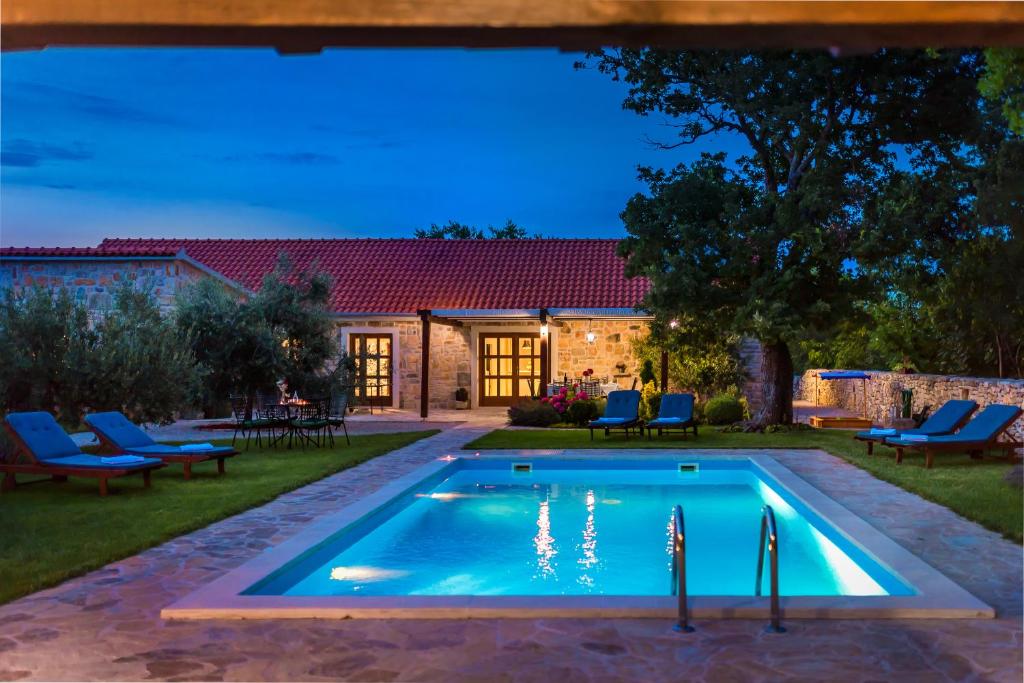 a swimming pool in the backyard of a house at Rural House Kod Slapa in Bogatić