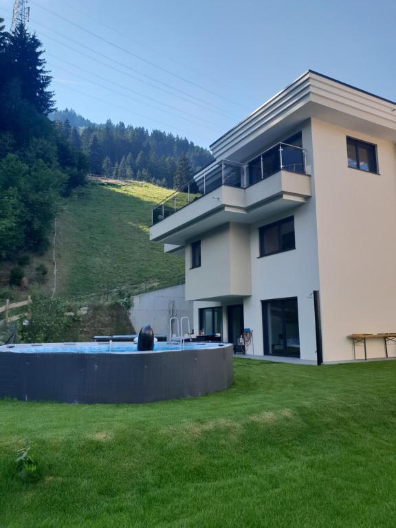 une maison avec une piscine dans une cour dans l'établissement Ferienwohnung Colleen, à Fügenberg