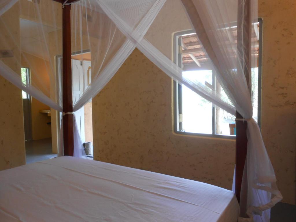 Säng eller sängar i ett rum på Taragala Chalets