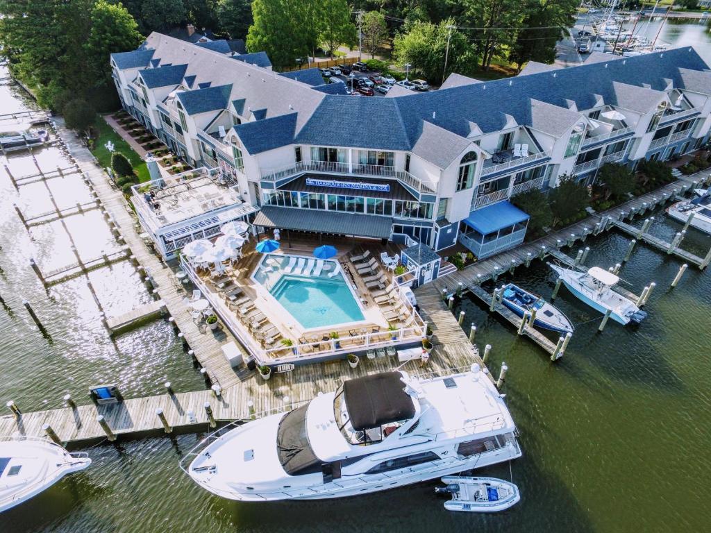 an aerial view of a large house with a boat in the water at St Michaels Harbour Inn, Marina and Spa in Saint Michaels