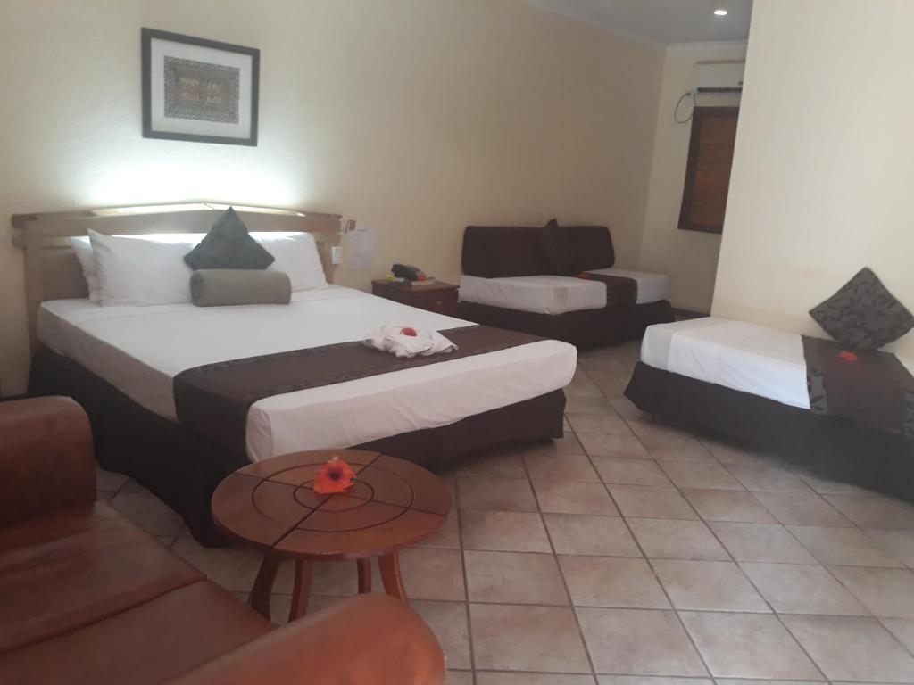 Postel nebo postele na pokoji v ubytování Grand Eastern Hotel