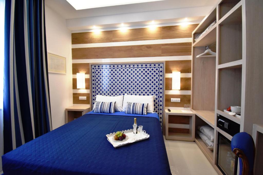 Postel nebo postele na pokoji v ubytování Melody Sorrento Suites