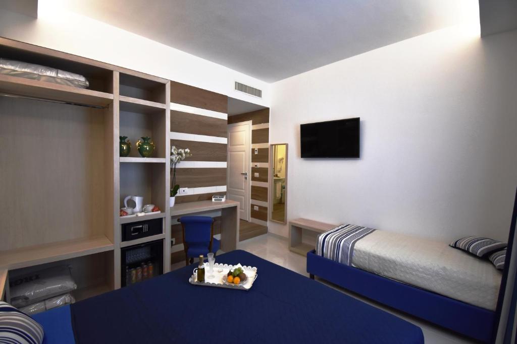 Postel nebo postele na pokoji v ubytování Melody Sorrento Suites