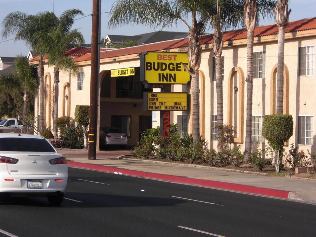 a white car parked in front of a burger inn at Best Budget Inn Anaheim in Anaheim