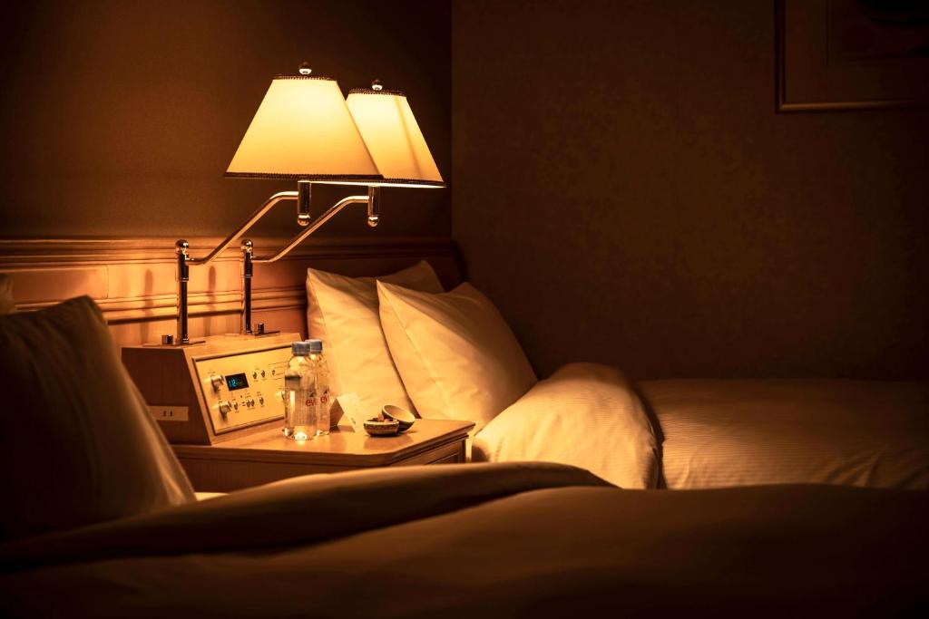 Postel nebo postele na pokoji v ubytování Hotel Agora Regency Osaka Sakai