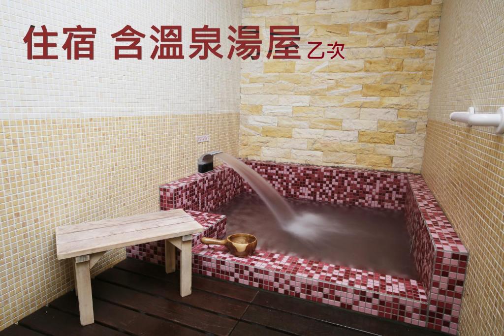 a bathroom with a tub with a water fountain at Long Shan Hotel in Jiaoxi