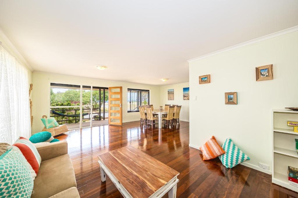 a living room with a couch and a table at Beachfront at Bribie in Woorim