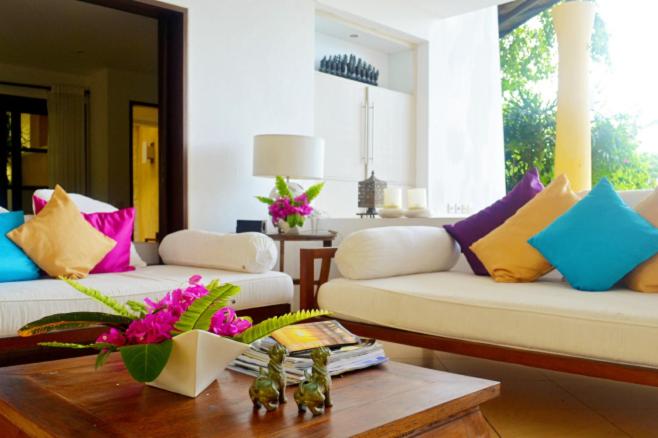 a living room with two couches and a coffee table at Villa Bidadari Kutuh Nusa Dua in Nusa Dua