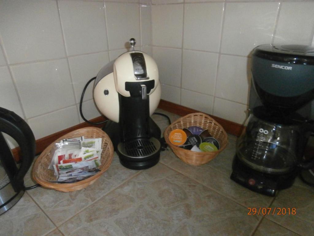 a coffee maker and two baskets of food at Apartman Aya in Janov nad Nisou
