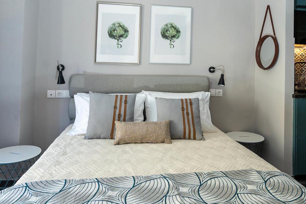 a bedroom with a bed with three pictures on the wall at Yasemi Studio 1 in Heraklio