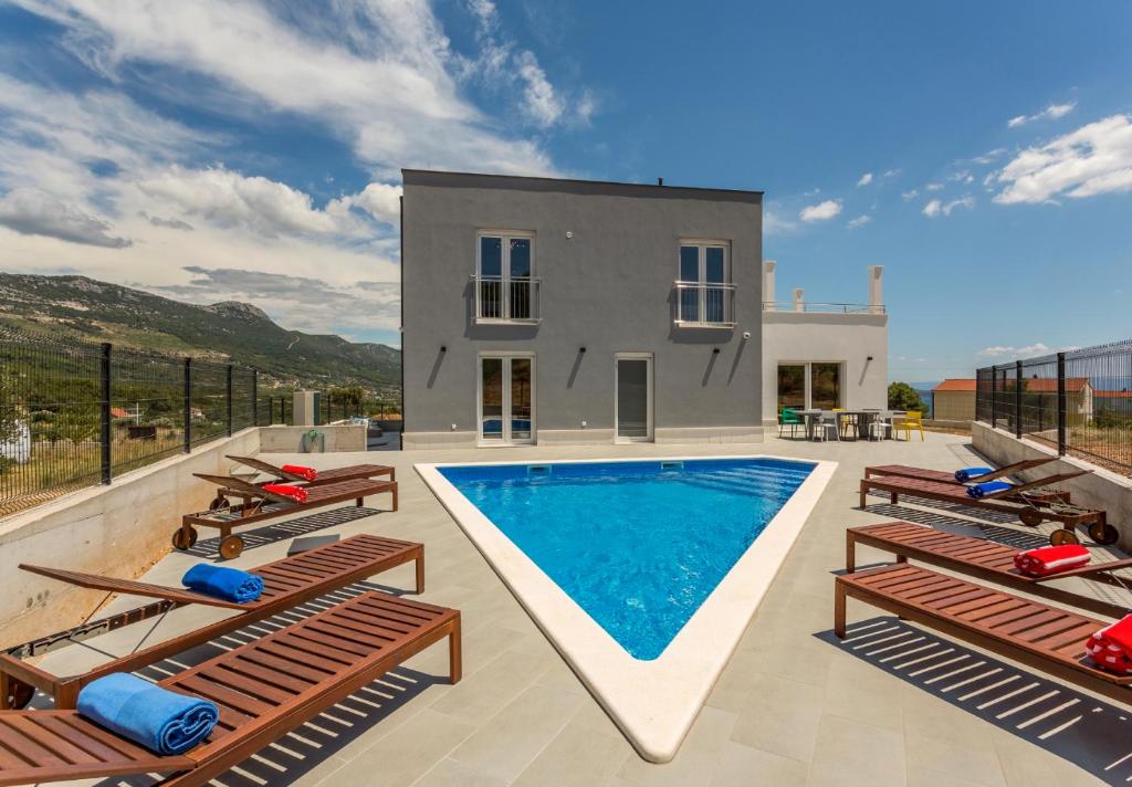 a villa with a swimming pool and a house at Villa Mila Kastela in Kastel Novi