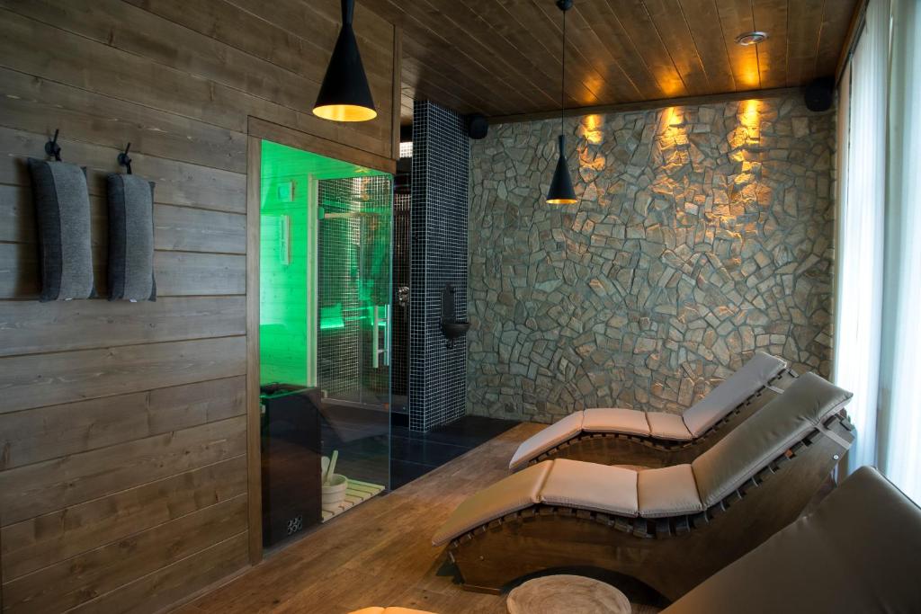 a living room with a bench and a wall at Hotel Na Baste in Jablonec nad Nisou