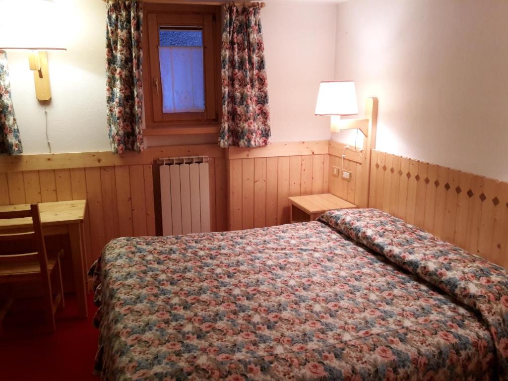 Postel nebo postele na pokoji v ubytování Hotel Locanda Grauson