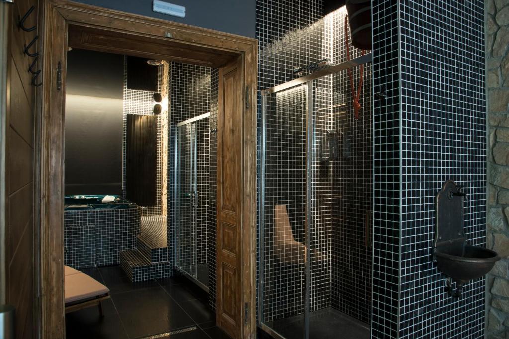 a bathroom with a shower with a toilet and a sink at Hotel Na Baste in Jablonec nad Nisou