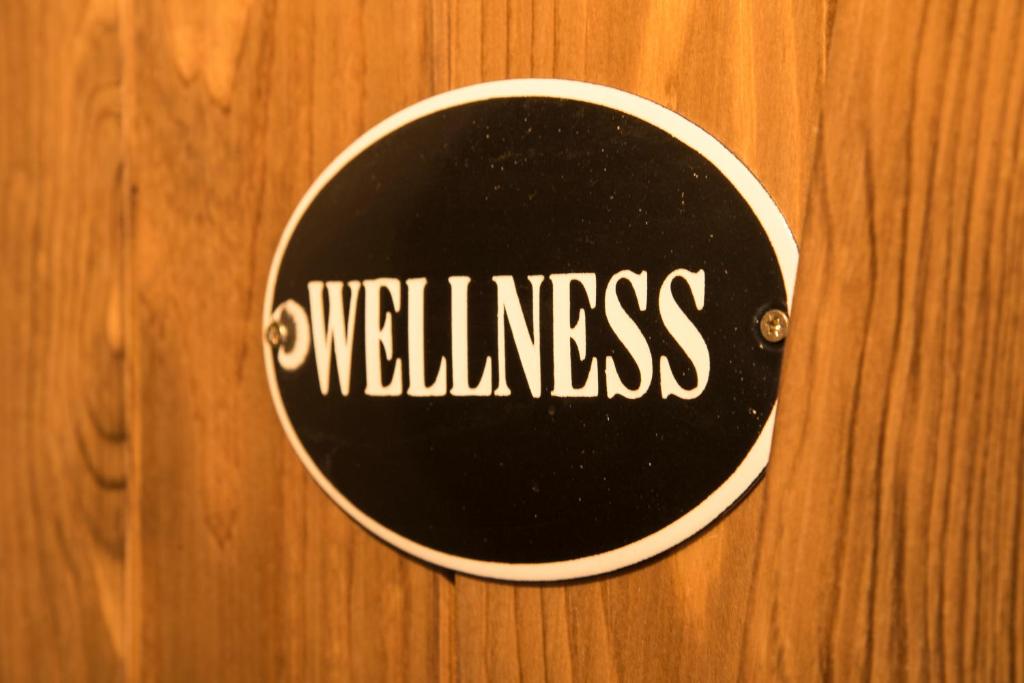 a sign on a wooden wall with the wordyssurance at Hotel Na Baste in Jablonec nad Nisou