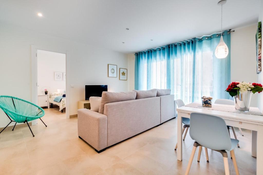 a living room with a couch and a table at Vivalidays Josep in Blanes
