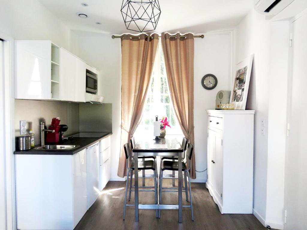 a kitchen with a small table and a window at La petite Maison in Grenoble