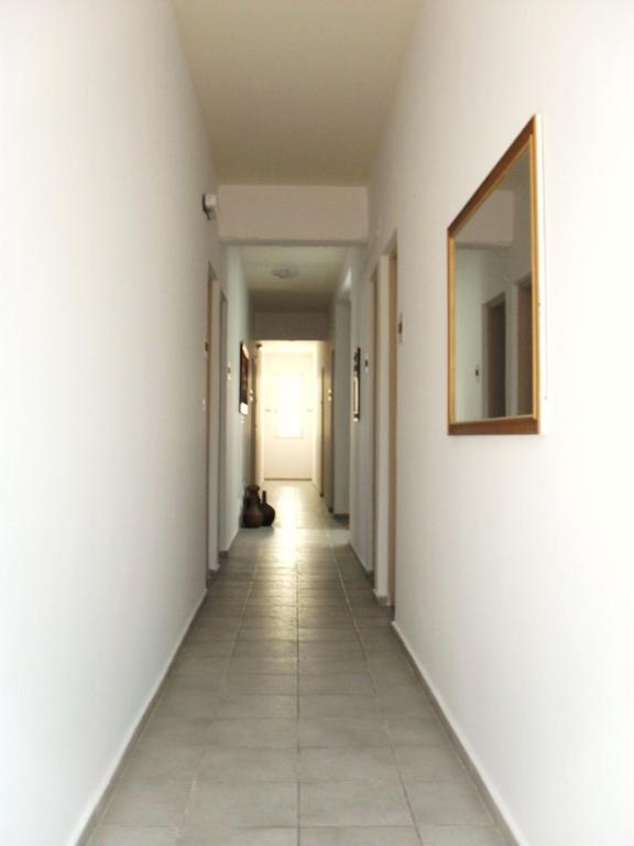a hallway with white walls and a mirror at La Santre Villa in Amoudara Herakliou