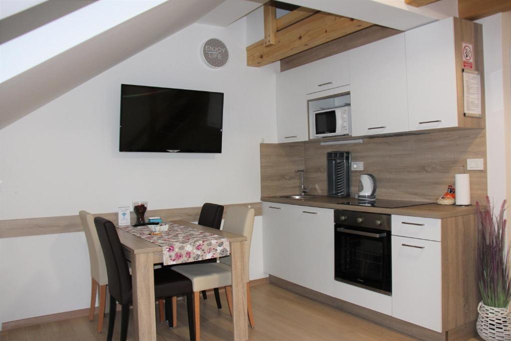 a small kitchen with a table and a kitchenette with a dining room at Apartments Borna 2 in Zagreb