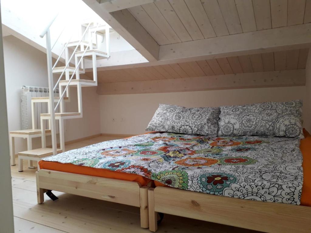 a bedroom with a bed and a ladder in it at Mansarda Settimo Cielo in Chioggia