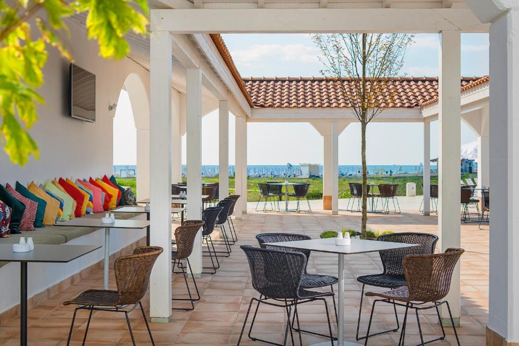 a patio with tables and chairs on a patio at Sunrise Blue Magic Resort - All Inclusive in Obzor