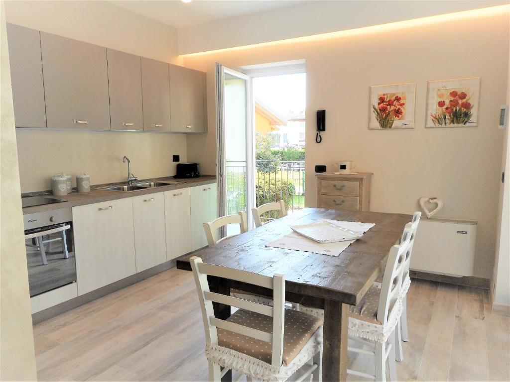 a kitchen and dining room with a wooden table at Lago d'Idro - Casa Emma in Ponte Caffaro