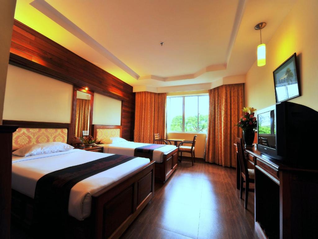 Postel nebo postele na pokoji v ubytování City River Hotel